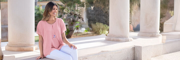 Dame in een roze blouse en een witte broek