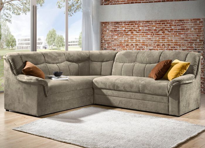 Gestoffeerde hoekbank met slaapfunctie die vrij in de ruimte geplaatst kan worden 