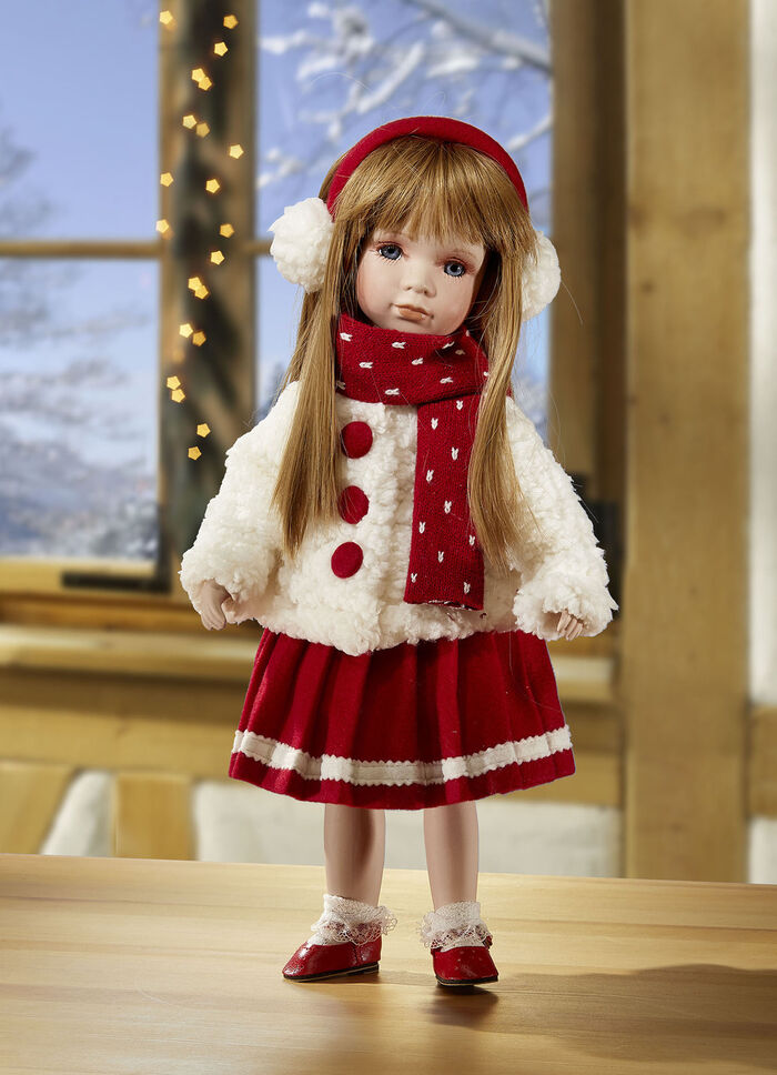 Porseleinen pop met winterkleren 