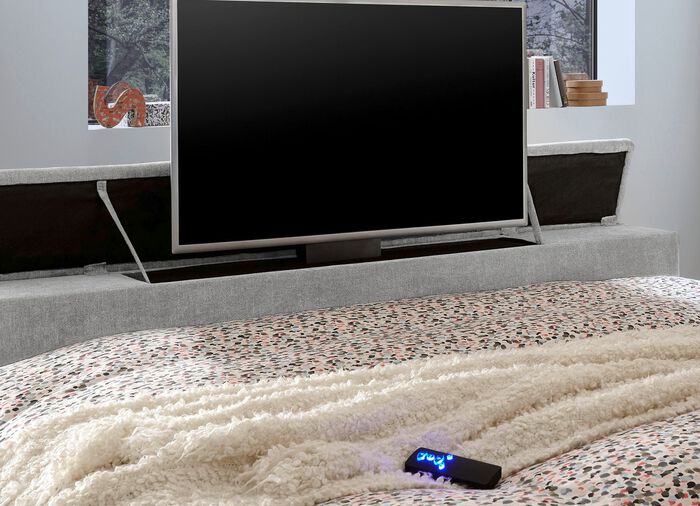 Boxspringbed met elektrisch uitschuifbare tv-beugel 