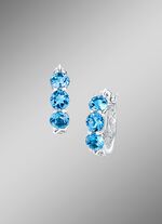 Versierde oorringen met blauwe topaas 