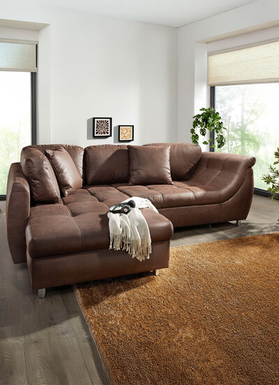 Vrijstaande gestoffeerde hoekbank met bedfunctie 