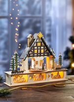 Verlicht houten boshuis 