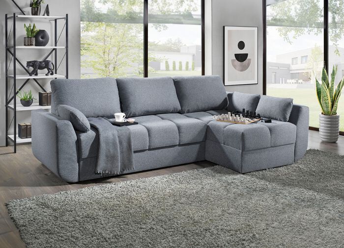 Gestoffeerde hoekbank met slaapfunctie die vrij in de ruimte geplaatst kan worden 