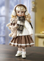 Porseleinen pop met winterkleren 