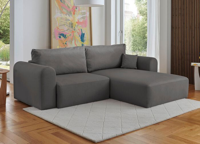 Gestoffeerde hoek met bedfunctie en decoratieve kussens 