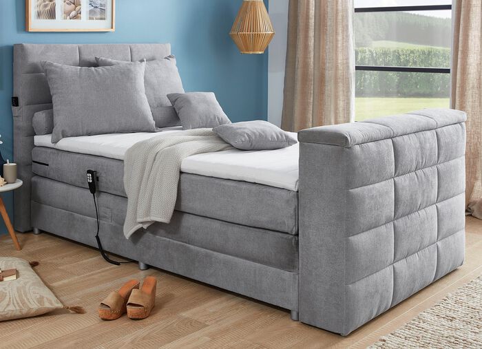 Boxspringbed met elektrisch uitschuifbare tv-beugel 